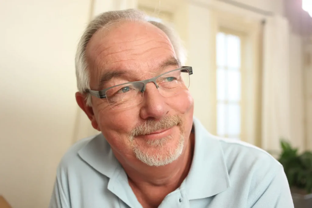 Close up of man smiling.