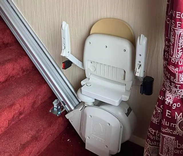 A stairlift with a folded seat.