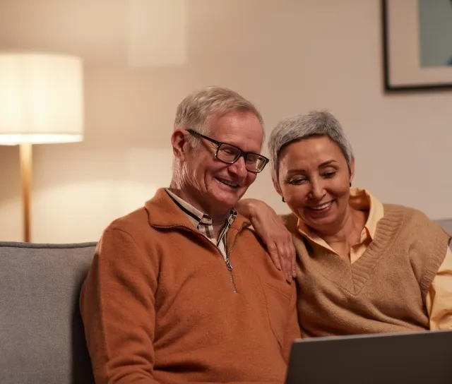 A couple happily considering improving their home with a stairlift.