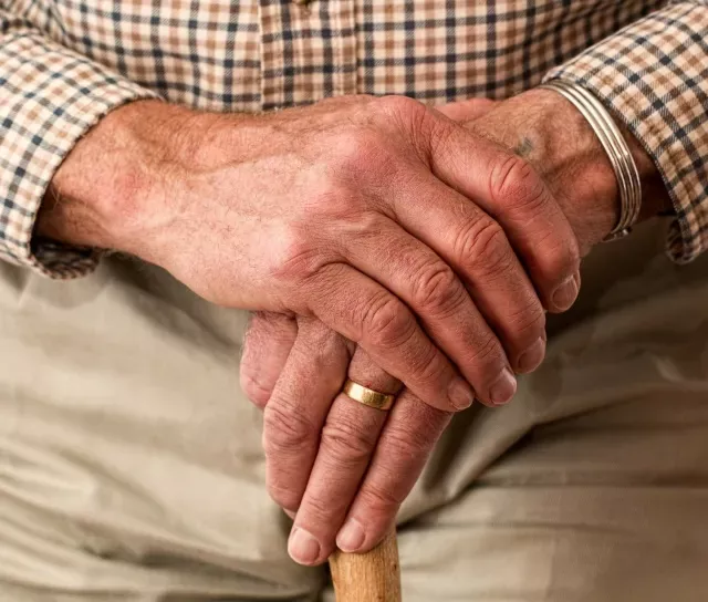 A closeup of an elderly man's hands