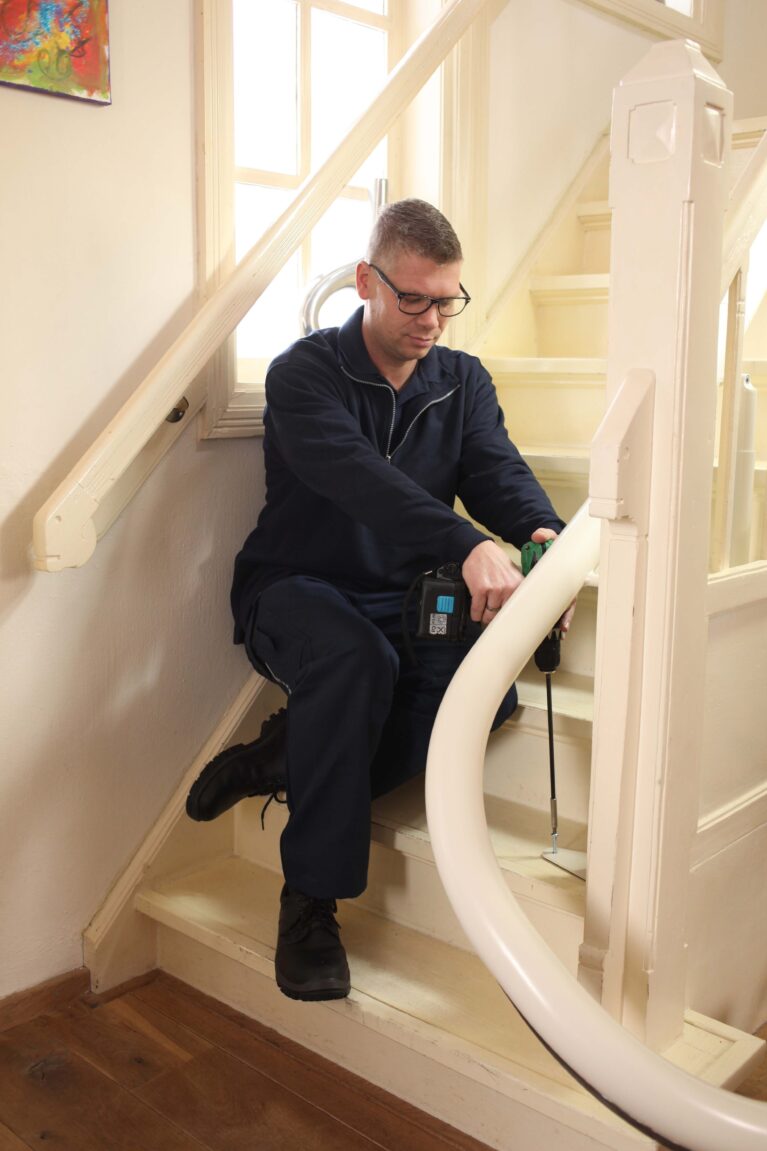 Engineer fixing a stairlift