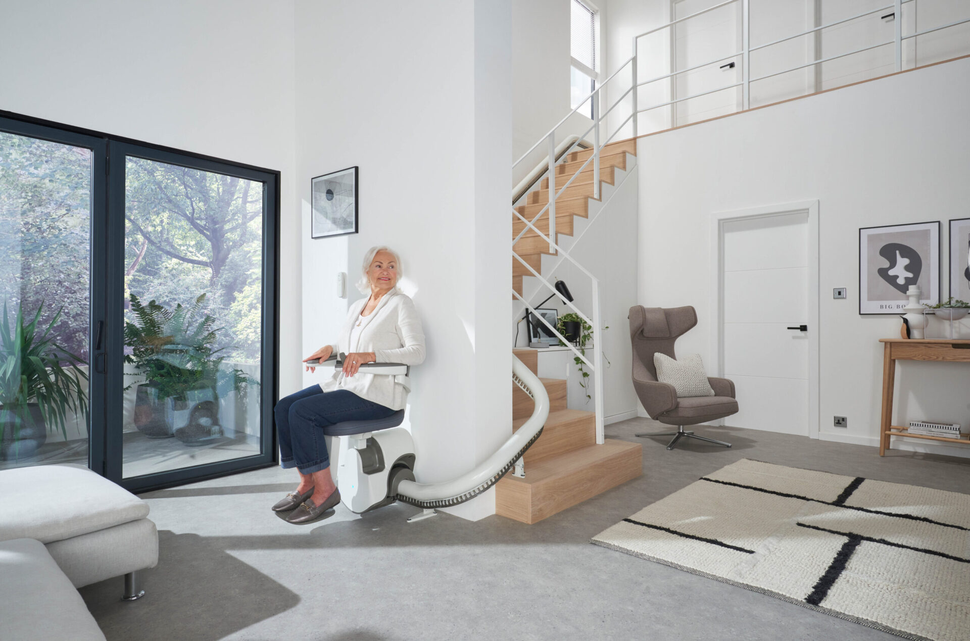 A picture of a woman on the Flow X stairlift