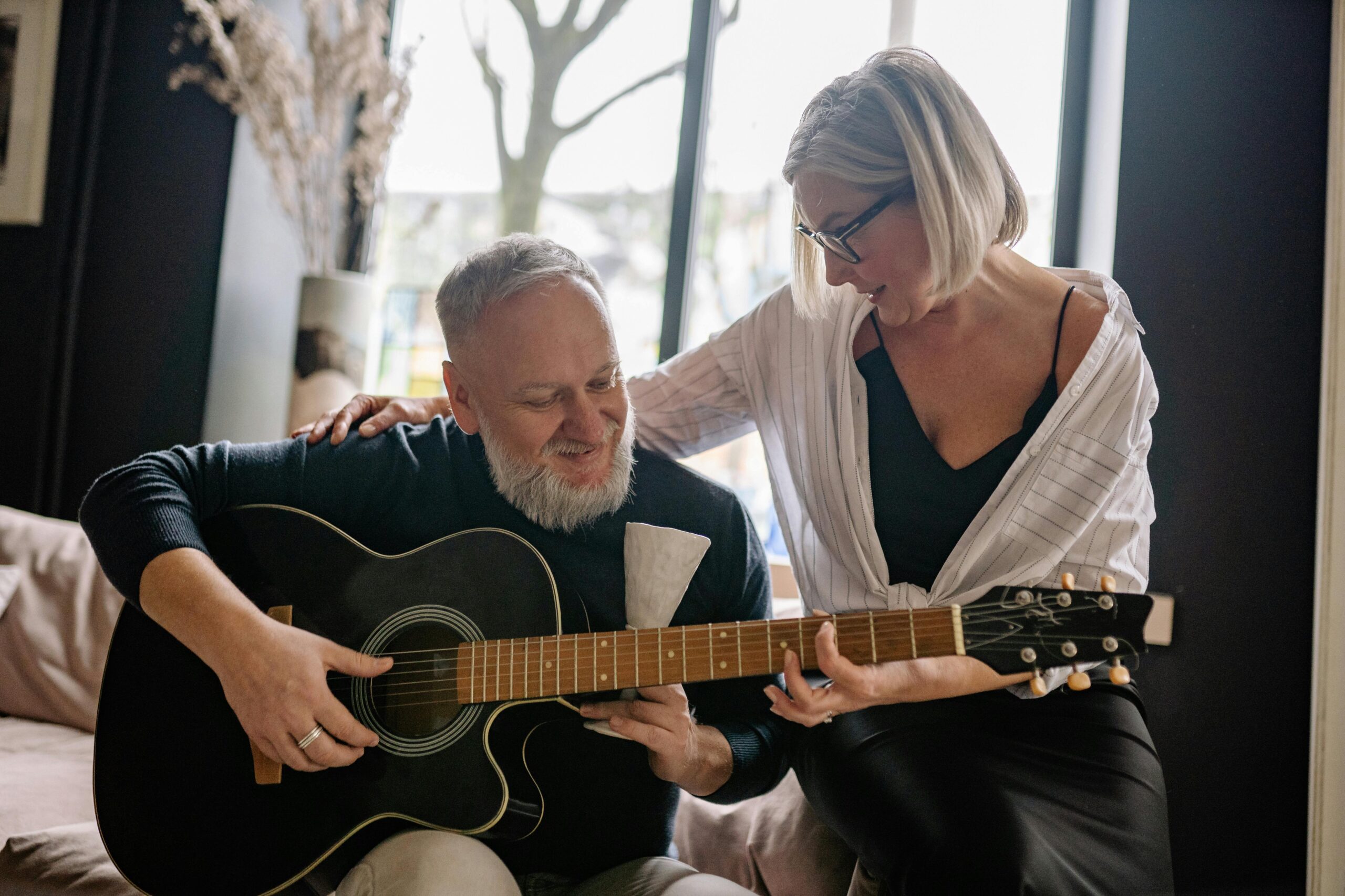 an older adult taking part in music therapy with a trained therapist