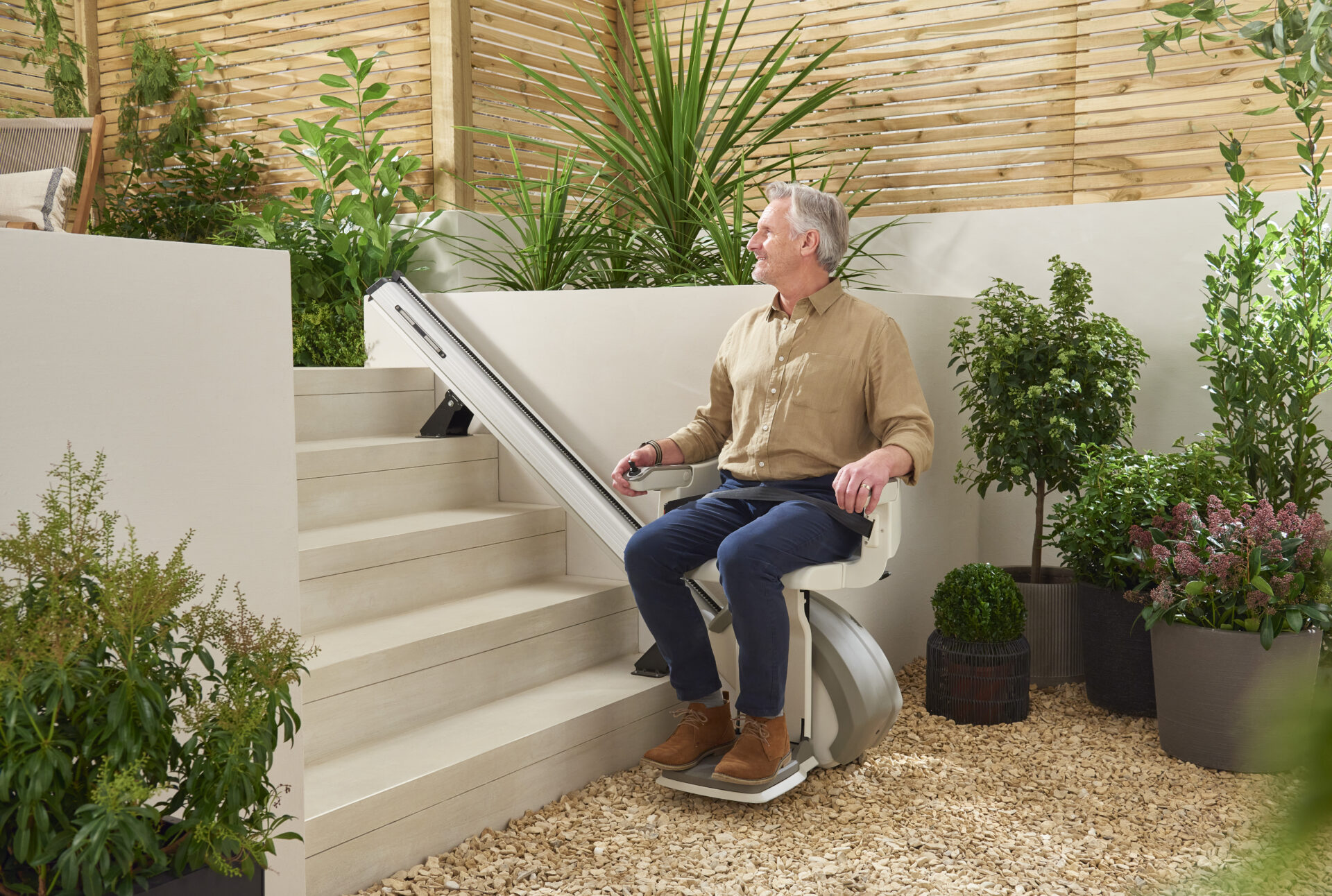 An older man enjoying the comfort of the homeglide outdoor stairlift