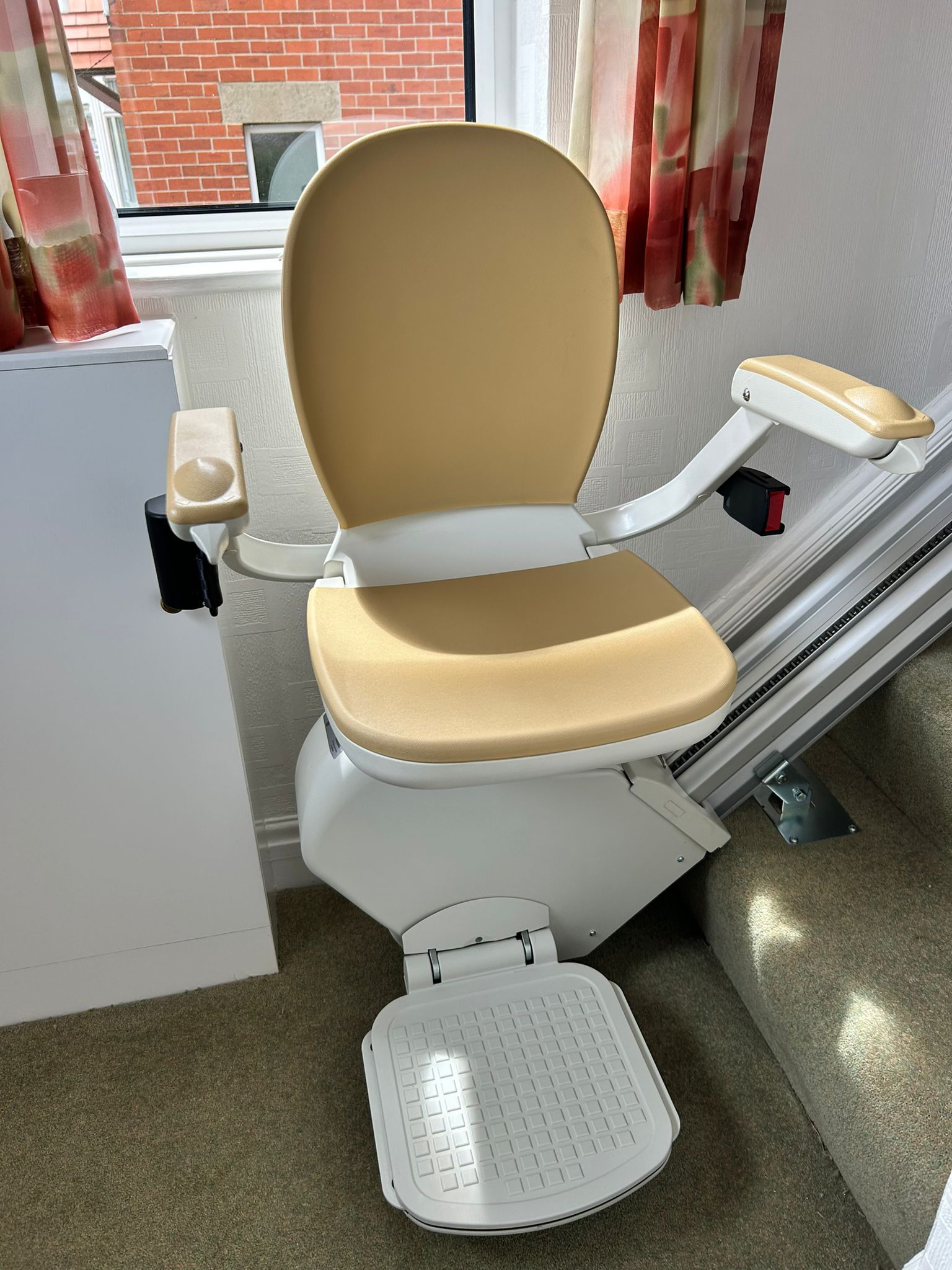 An Acorn 130 T700 stairlift neatly parked in its charging station