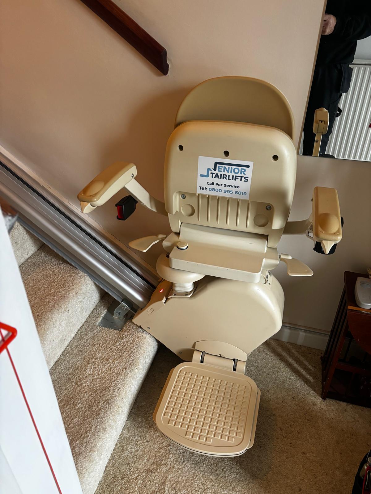 A brooks 130 stairlift parked at the bottom of the stairs