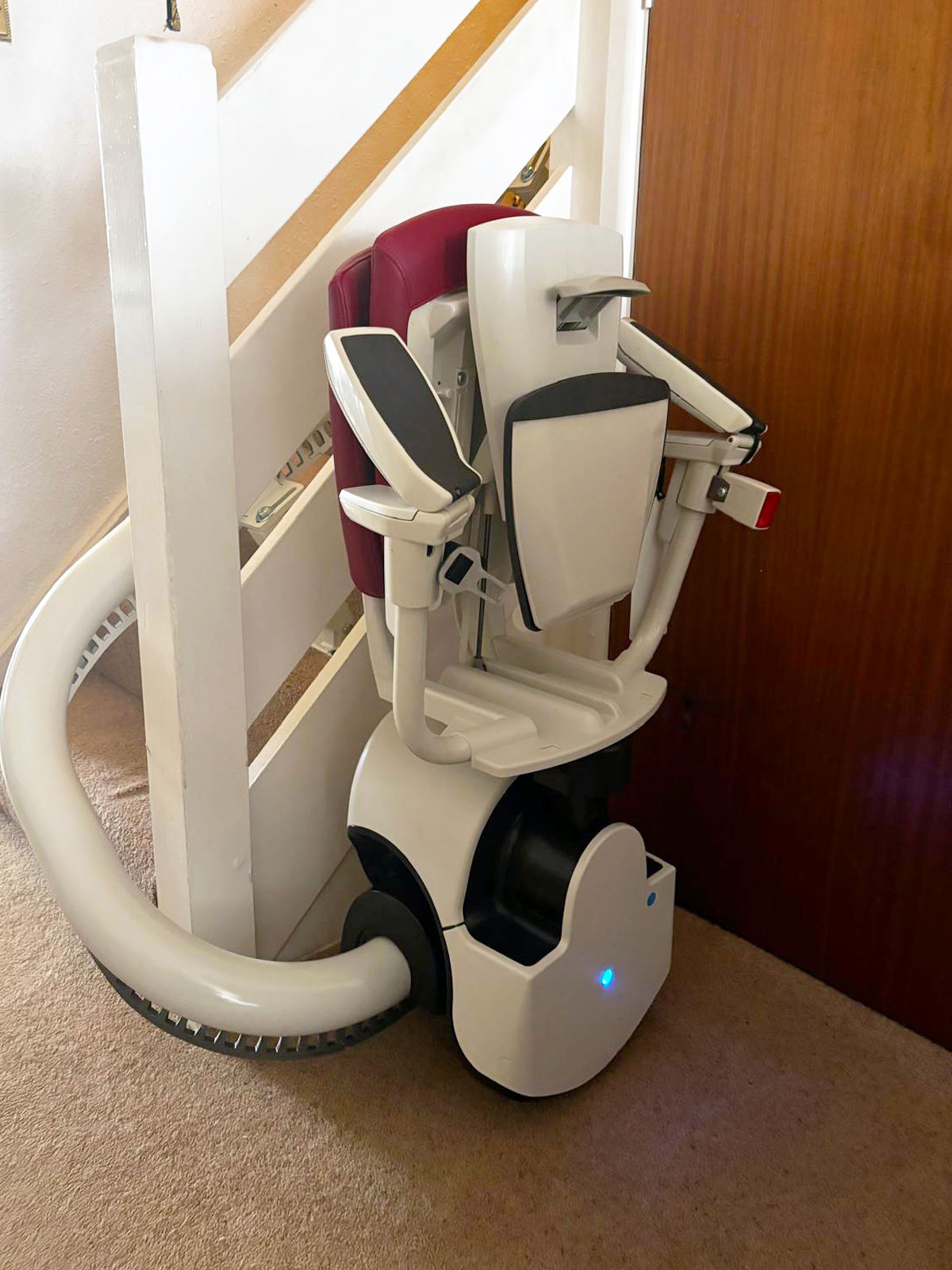 A gorgeous flow 2a stairlift with a red seat