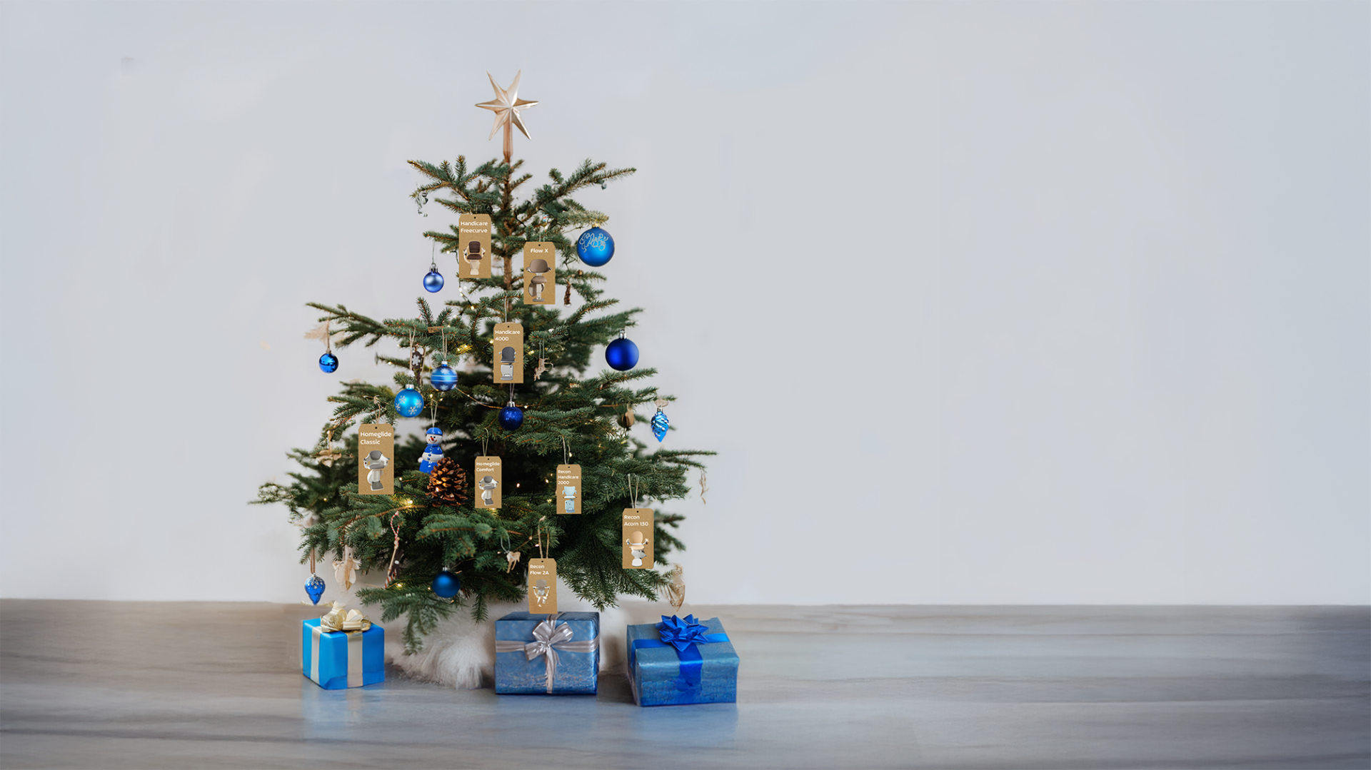 A picture of a christmas tree with blue ornaments & stairlift tags in a grey room.