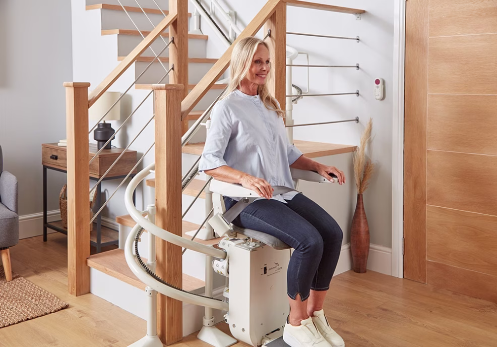 A woman enjoying the comfort that a platinum ergo curved stairlift.