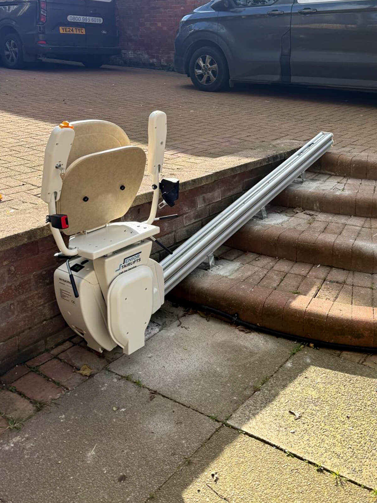 Handicare 1000 outdoor stairlift installed in a flourishing garden