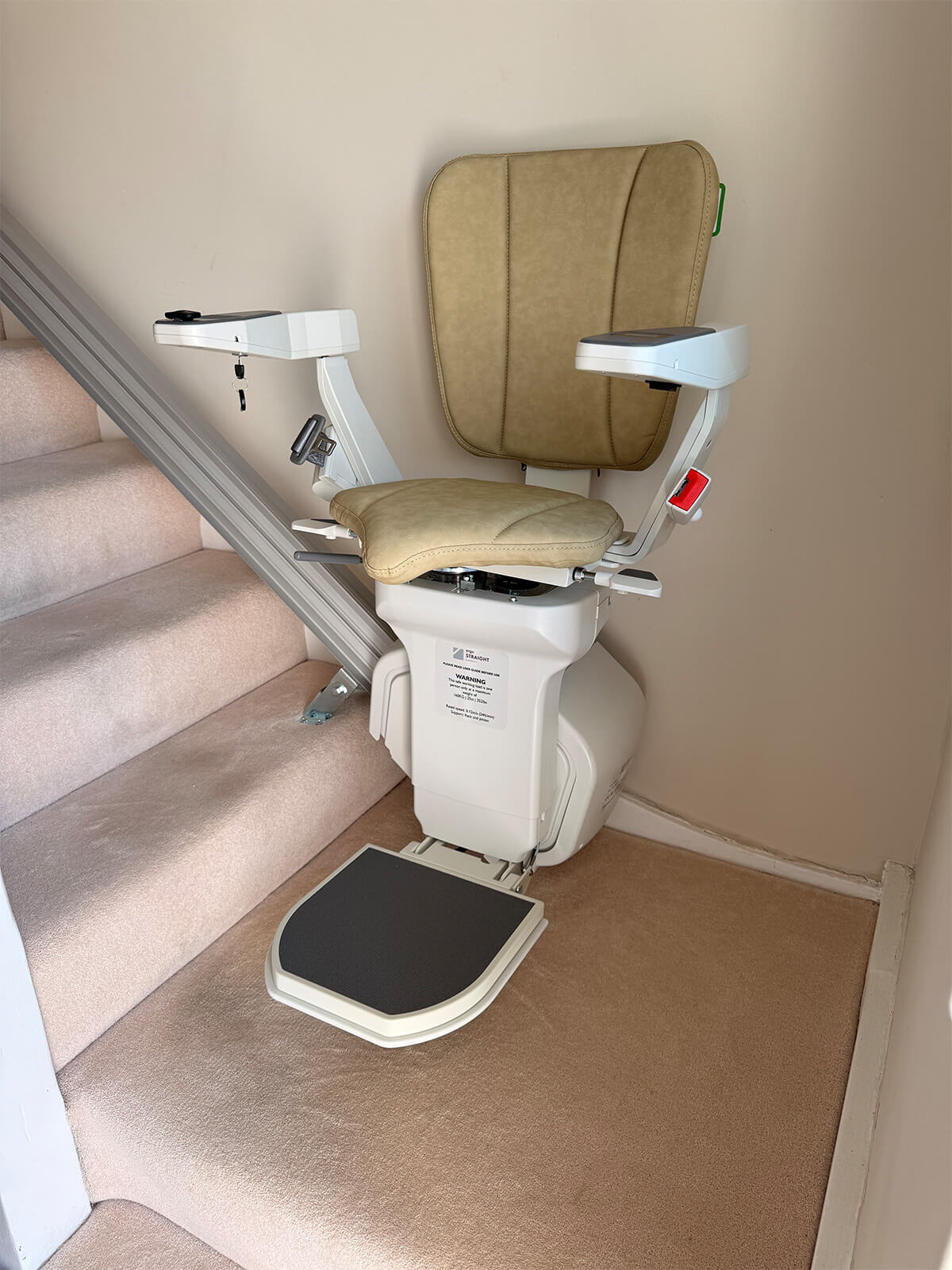 A closeup of an Acorn Stairlift in a home.