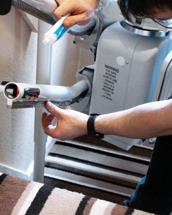 Engineer fixing a stairlift